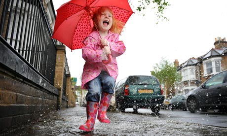 Child jumping in puddle
